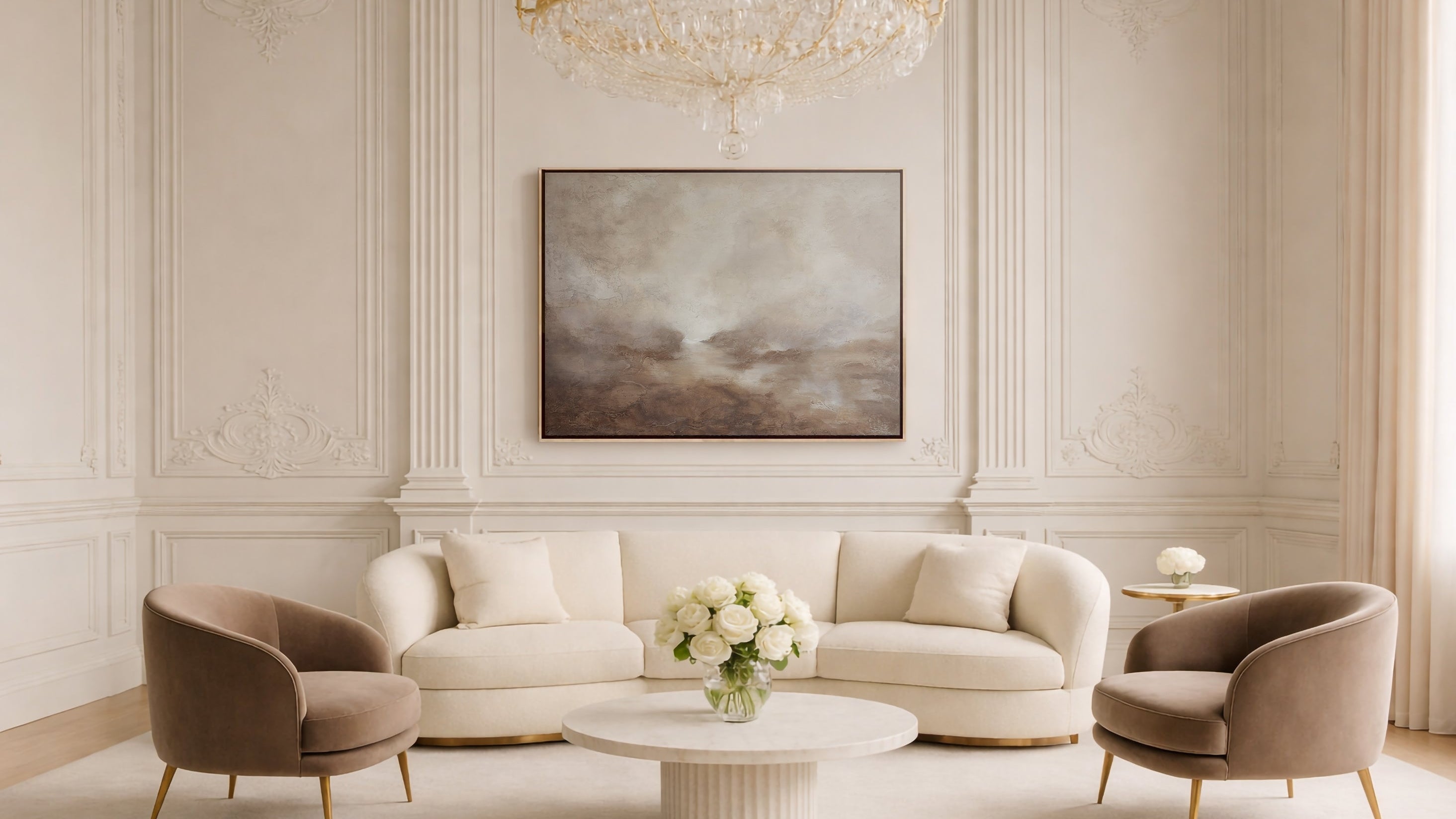 abstract art in a Luxurious living room with beige sofa, armchairs, and a chandelier.